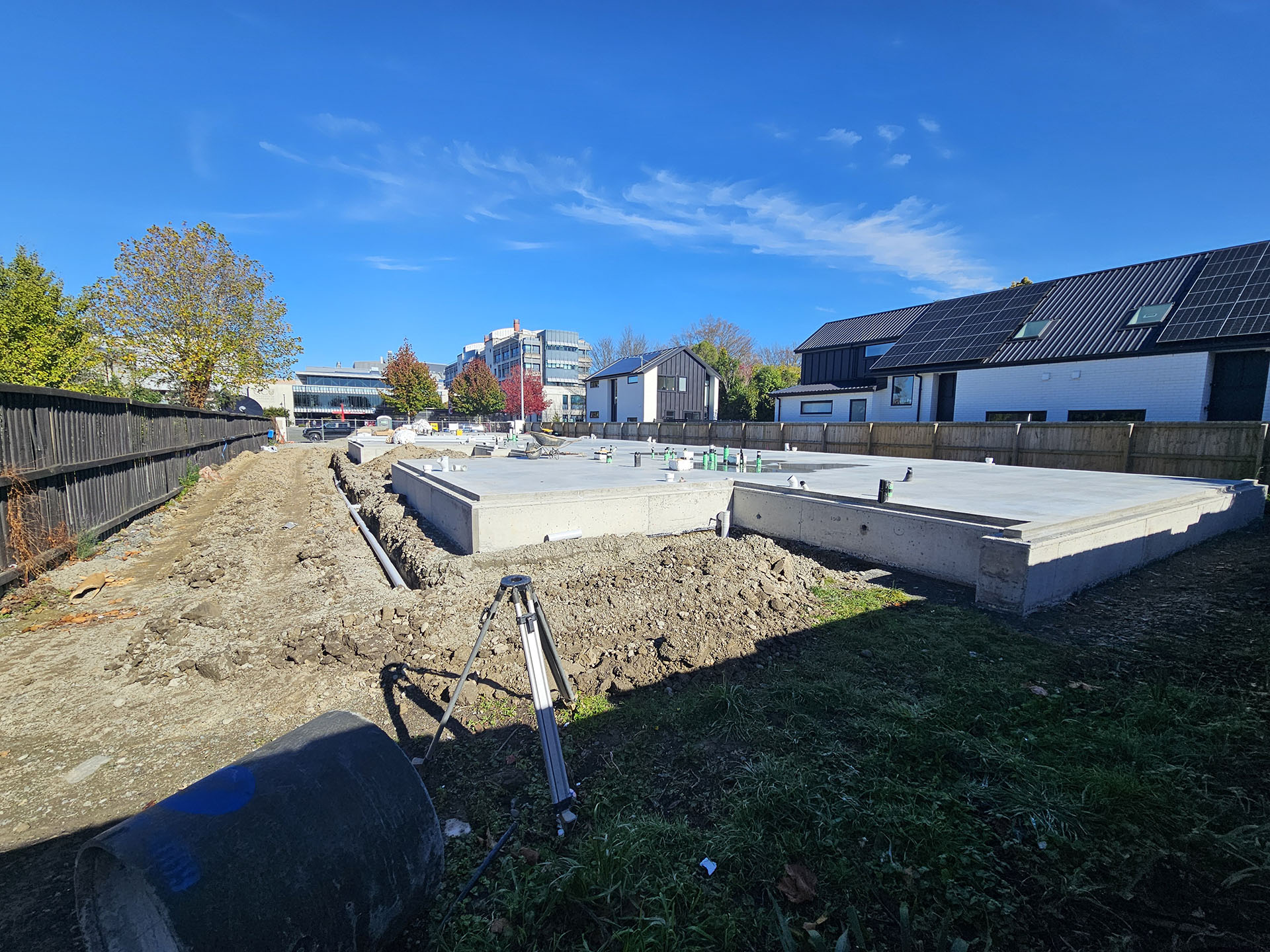 Foundation slabs complete — April 2026, UC visible in background